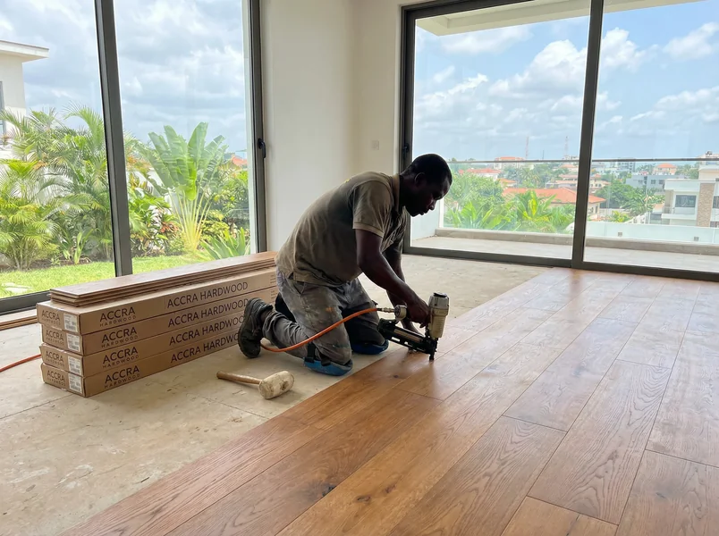 Team installing engineered hardwood planks in Ghana